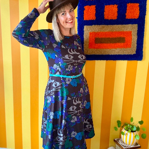 Woman in a colorful midi dress by SHALMIAK. Design: MAGICAT mystic.