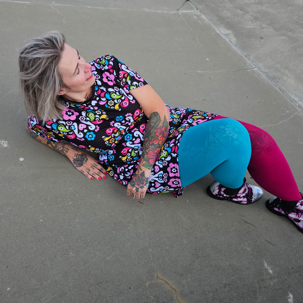 A woman wearing a colorful t-shirt dress by SHALMIAK. Design: PEACOCK LOVE.