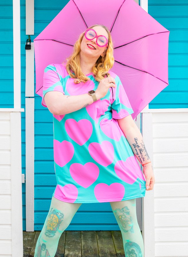 Woman in a colorful t-shirt dress by SHALMIAK. Design: ELLIE LOVE pink mint.